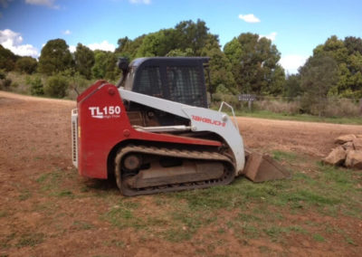 Skid steer loader working in a tight residential space