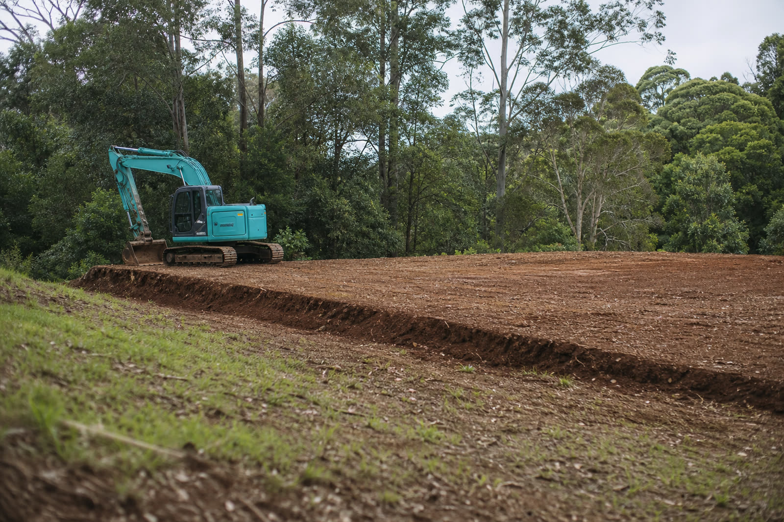 A freshly graded house pad on a sloping acreage block